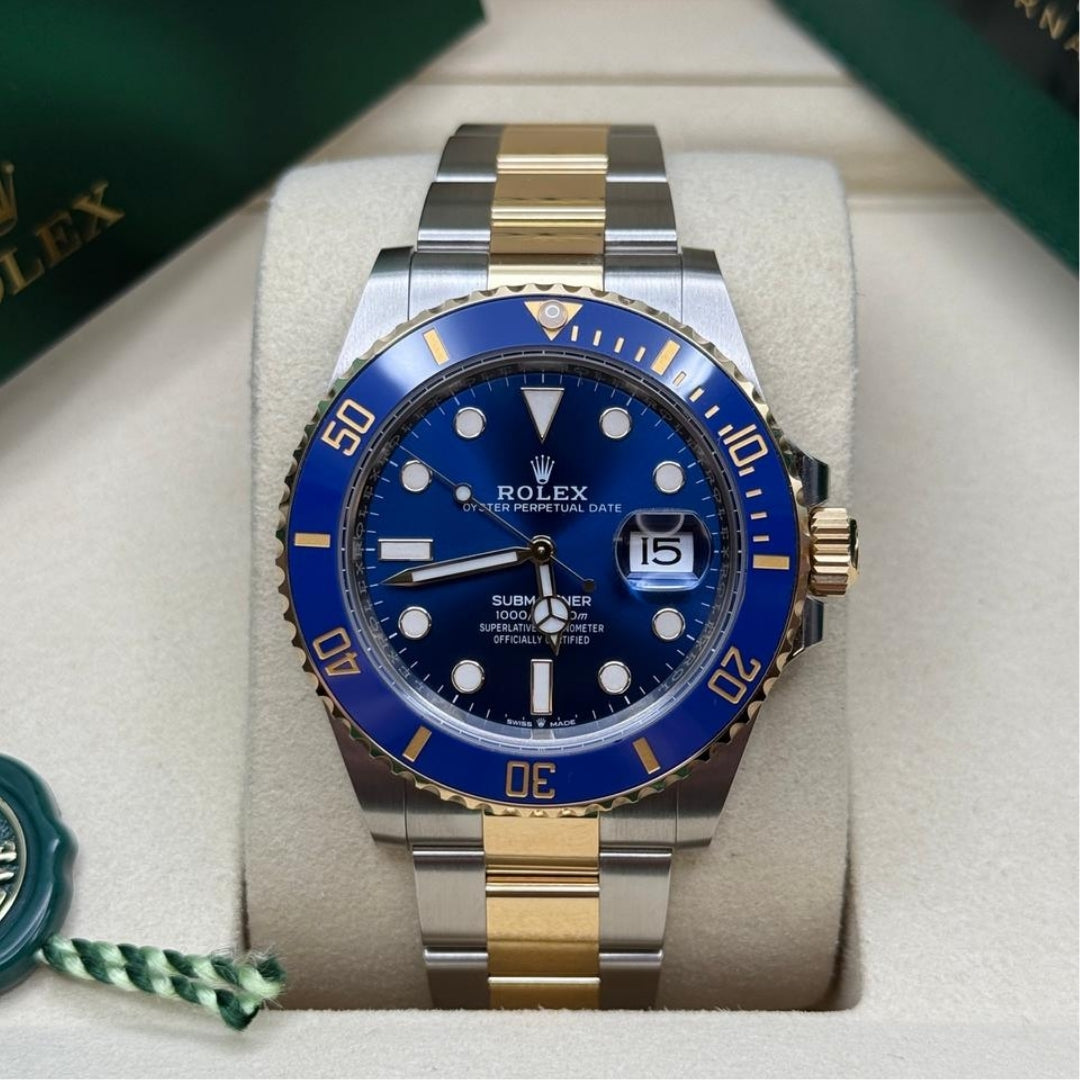 Blue and gold watch in presentation box, front view